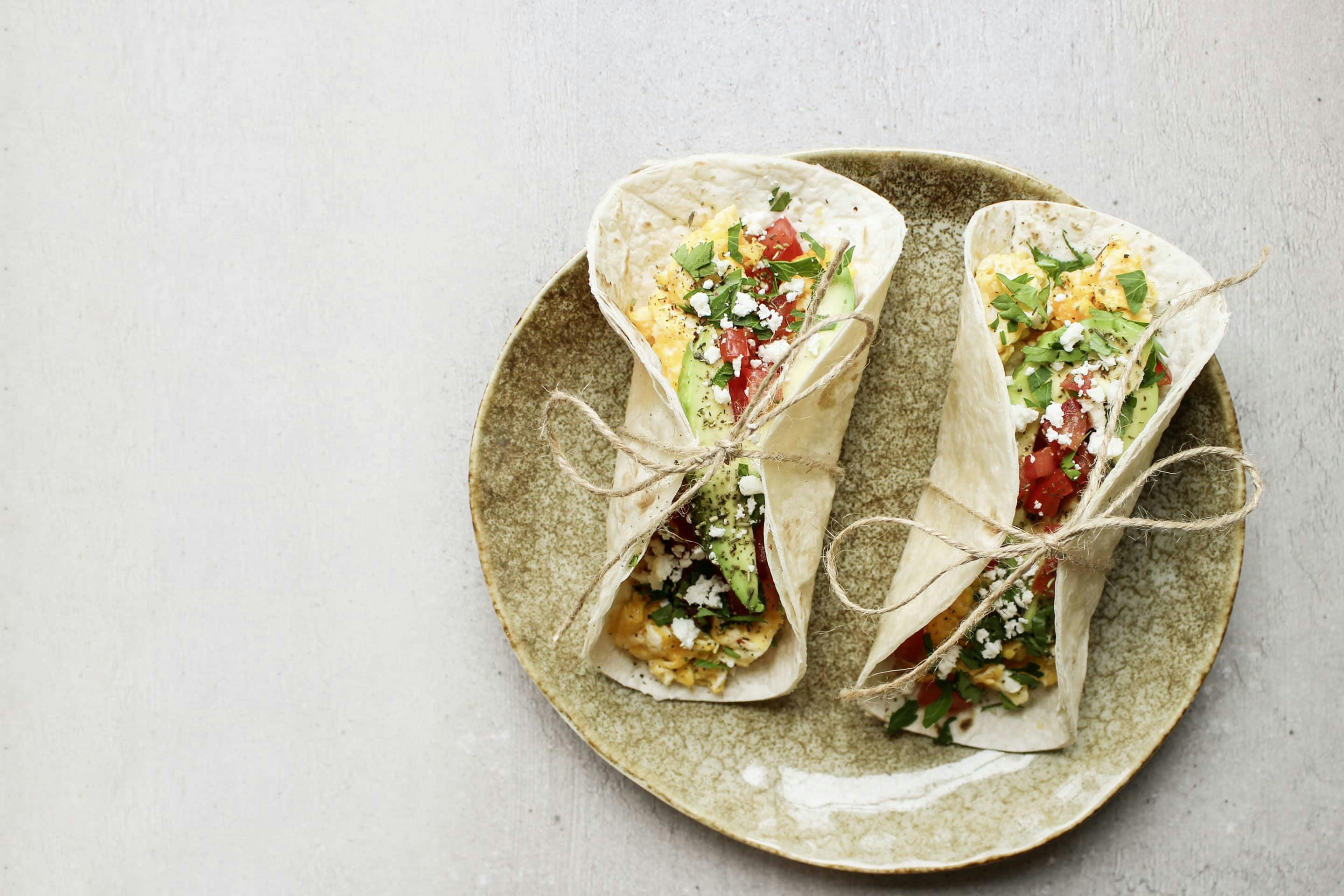 Breakfast tacos with herbs Rustikana on a beige plate tied with a thread