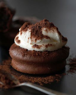 a chocolate cake with whipped cream topping