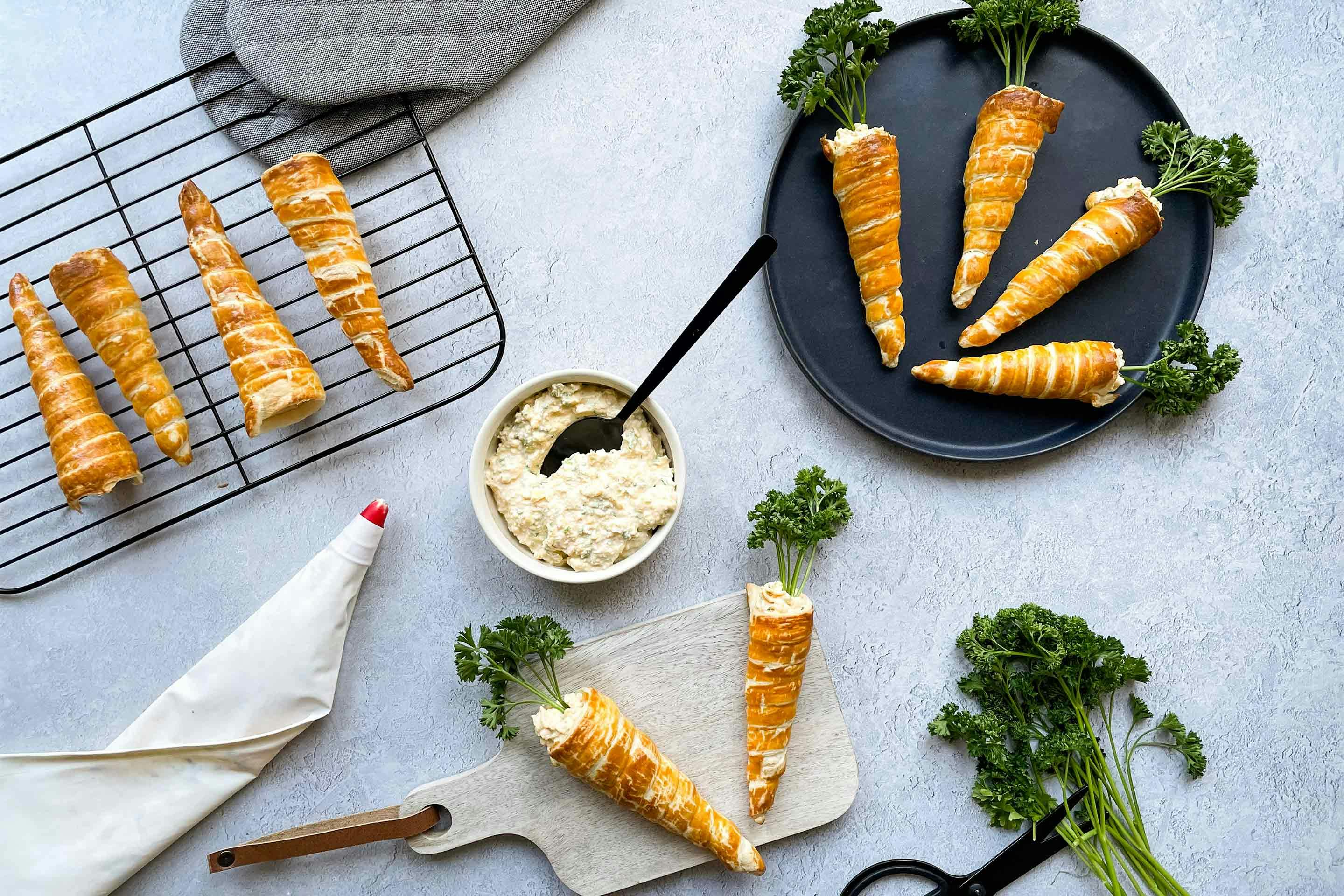 Freshly prepared puff pastry carrots filled with delicious egg spread.