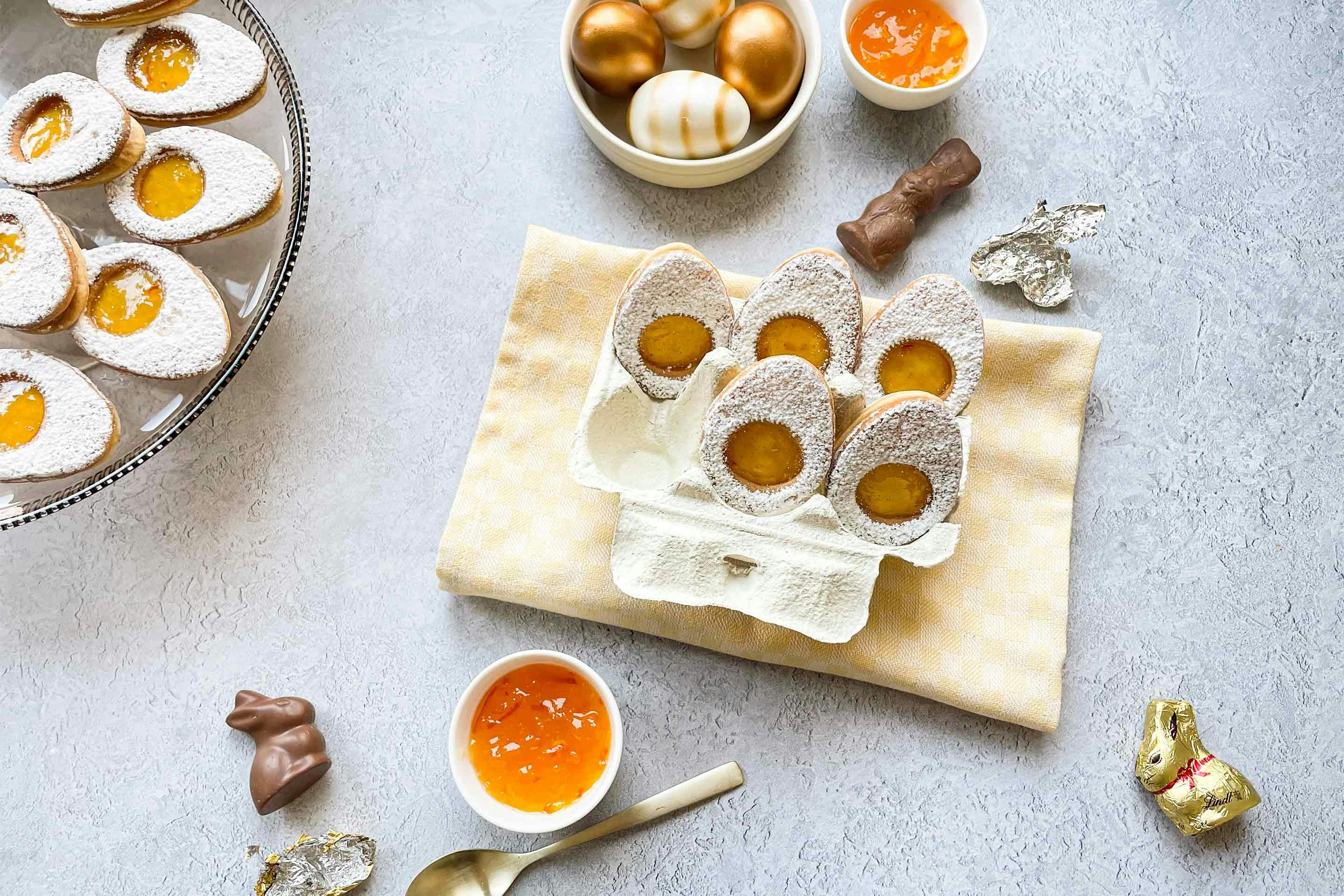 Easter egg shortbread biscuits filled with orange jam in an egg carton.