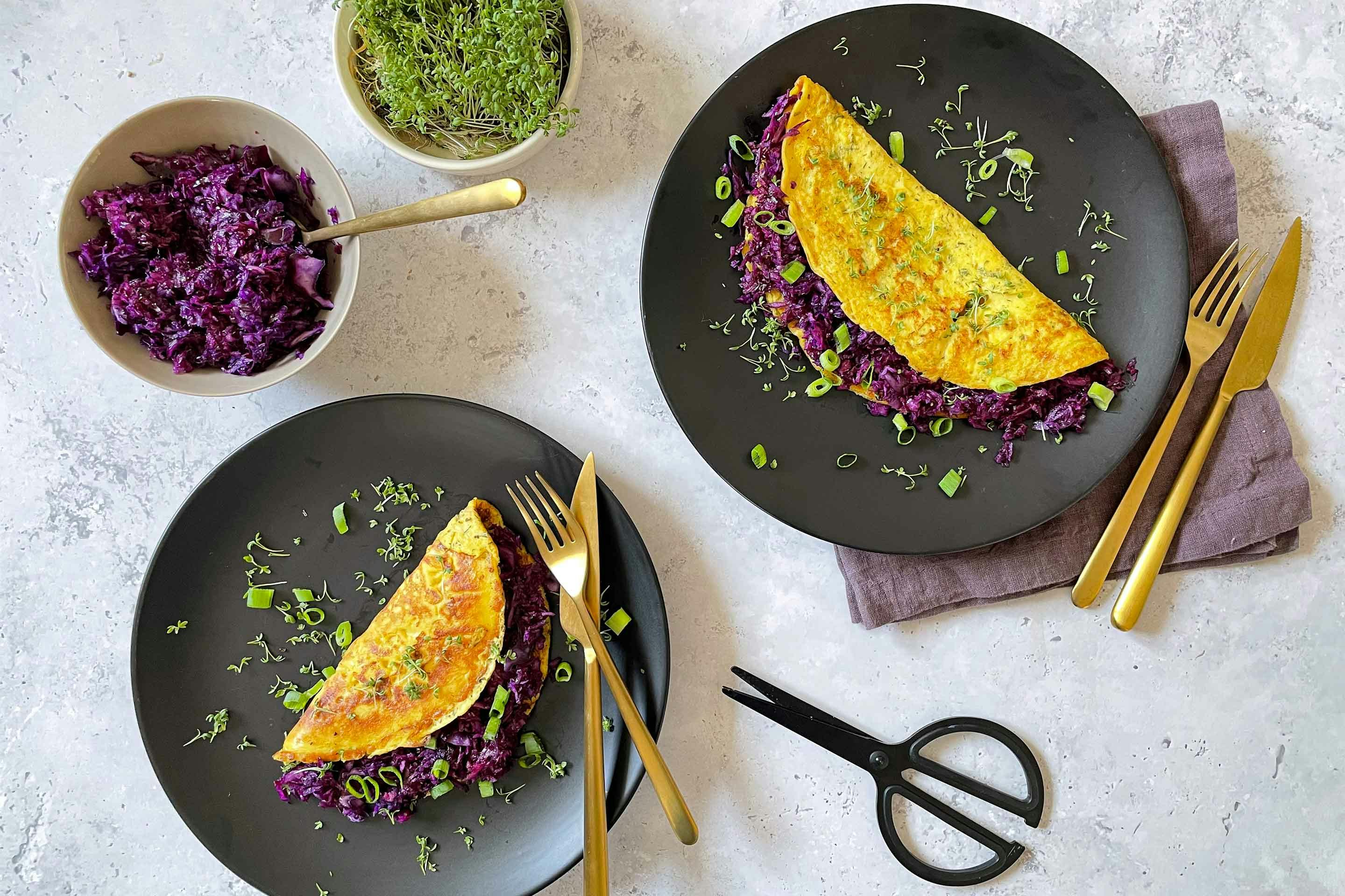 Herb omelet filled with crunchy red cabbage, garnished with cress.