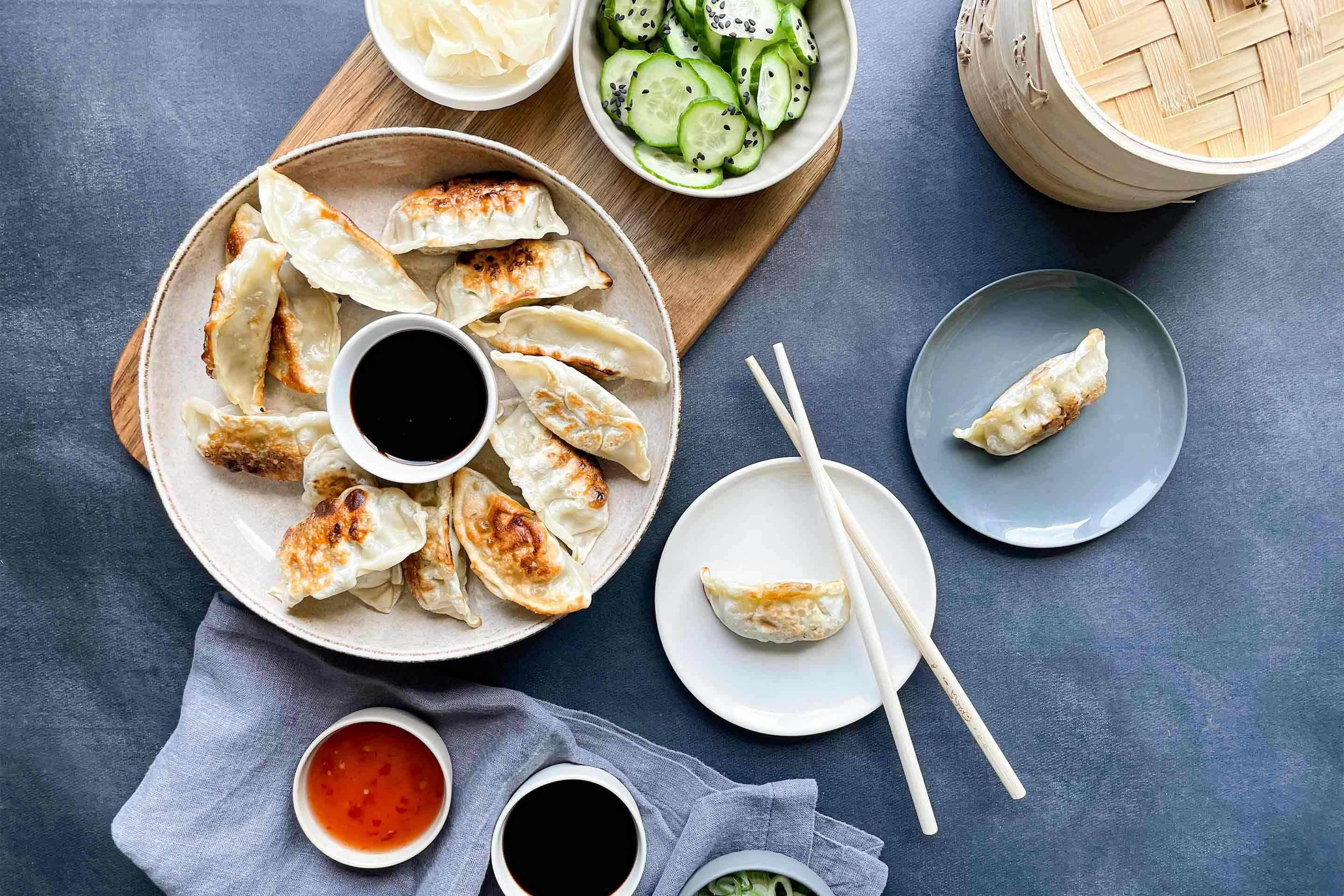 Delicious veggie gyoza with vegetable filling and cucumber salad.