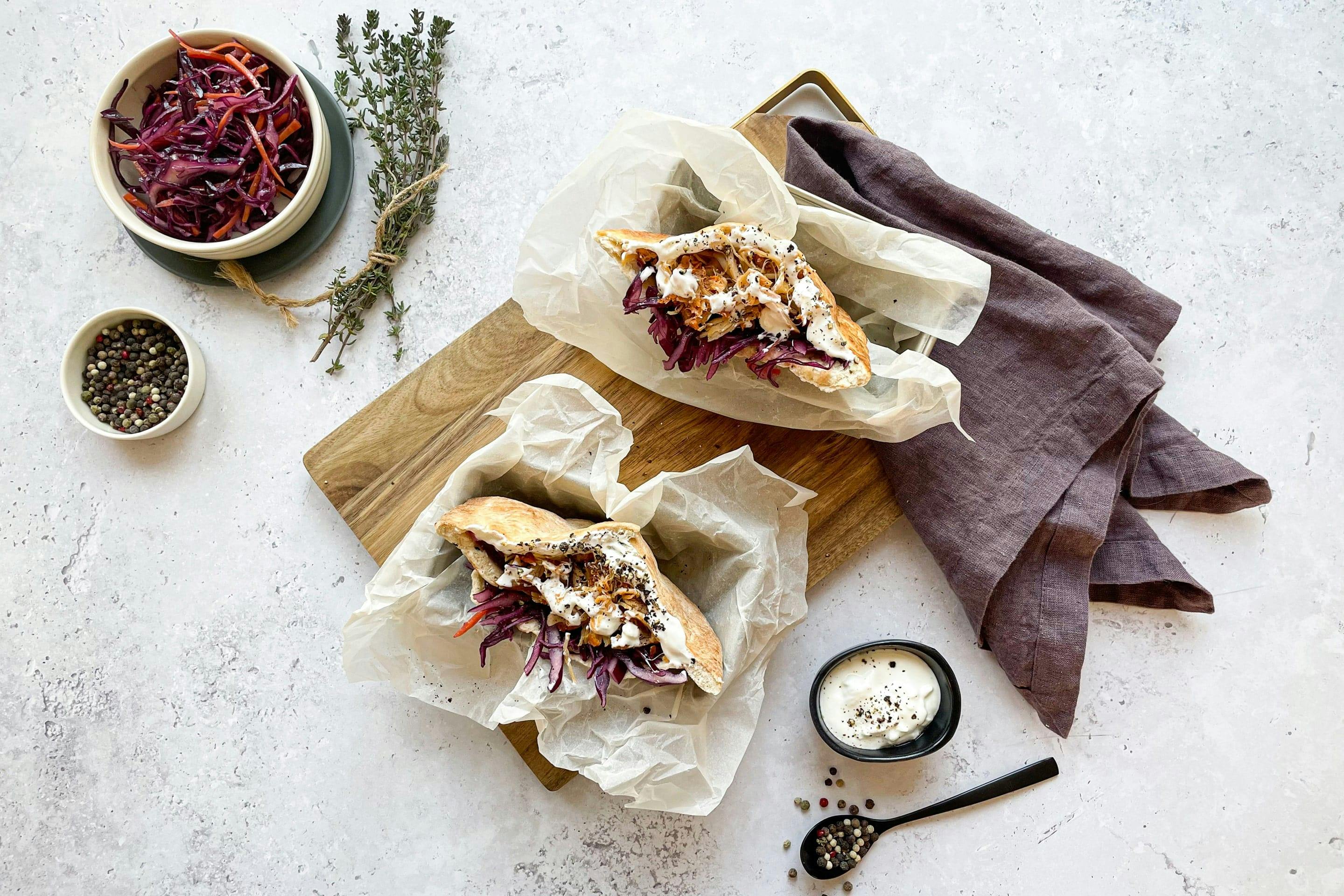 Aromatic pulled chicken sandwiches with coleslaw.