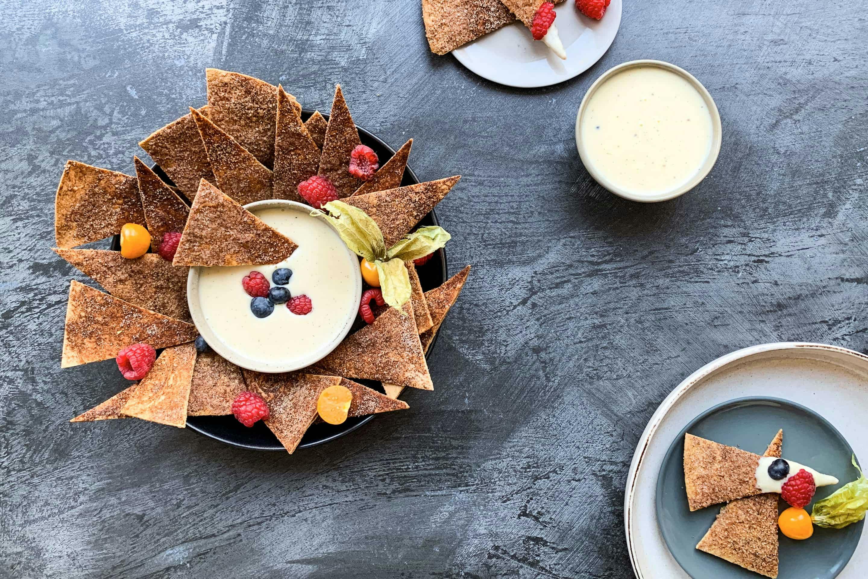 Sweet tortilla chips topped with vanilla dip and fresh berries