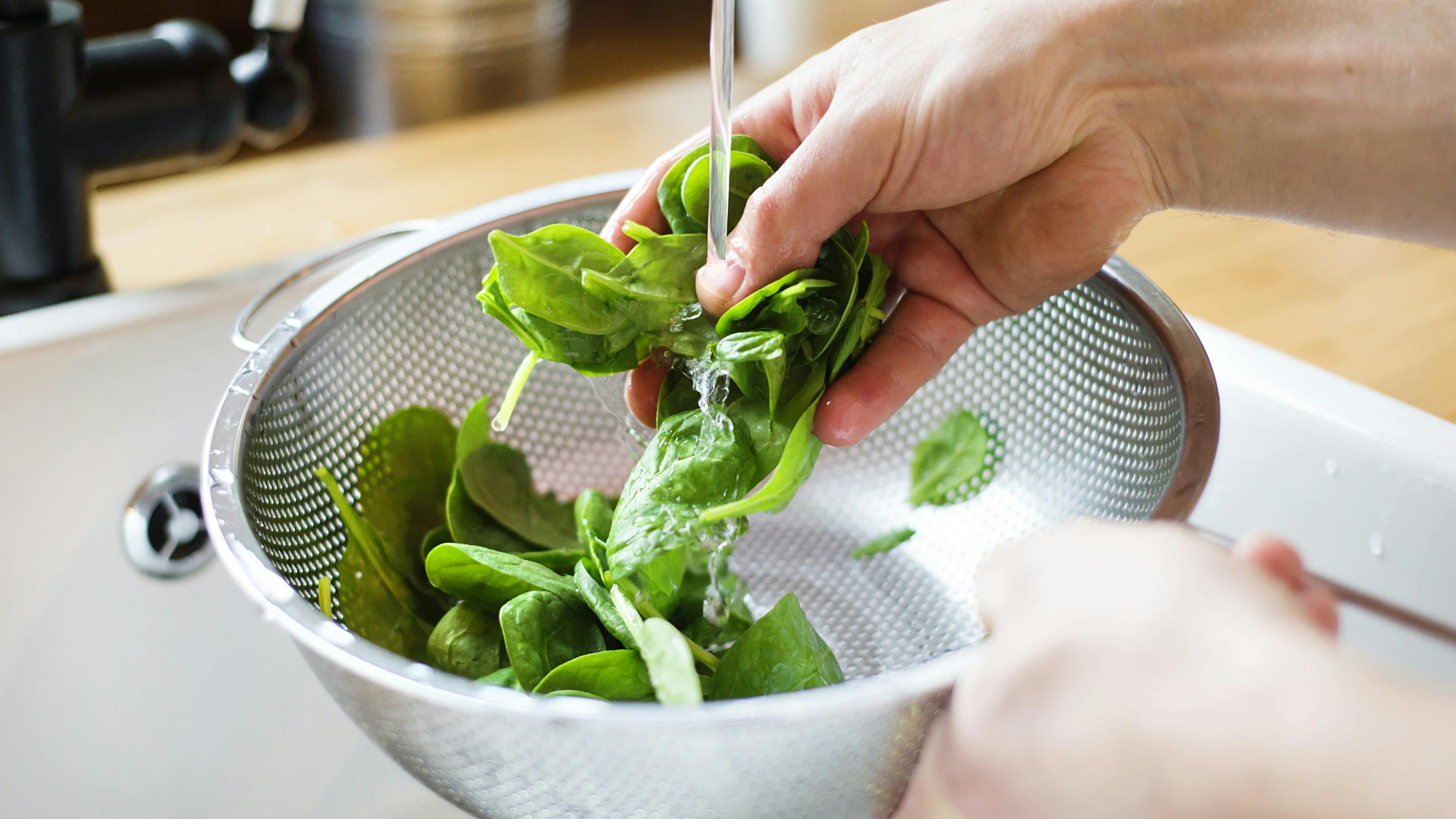 Washing a handful of fresh basil